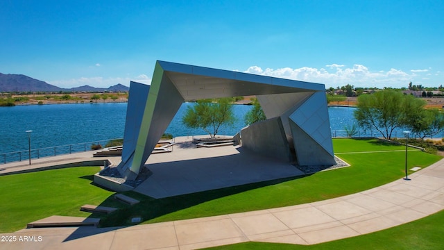 surrounding community featuring a yard and a water and mountain view