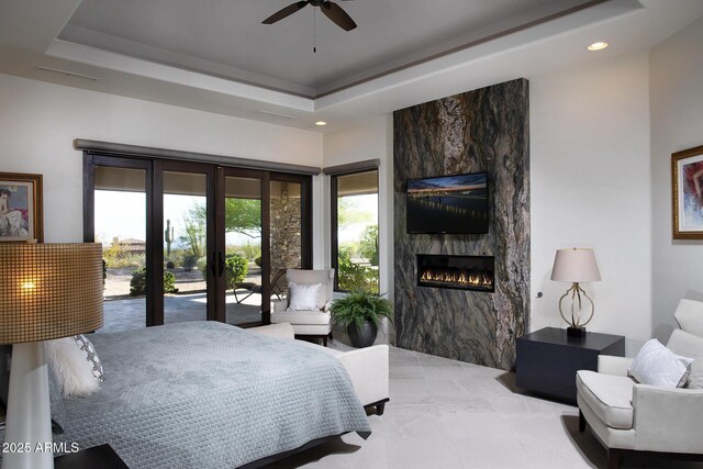 10205 E Happy Valley Rd, Scottsdale, AZ 85255 - bedroom with a large fireplace, french doors, access to outside, recessed lighting, and a tray ceiling