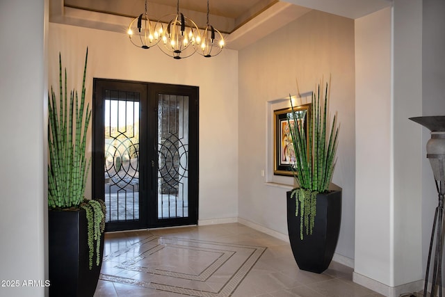 10205 E Happy Valley Rd, Scottsdale, AZ 85255 - tiled entrance foyer featuring french doors, a chandelier, baseboards, and inlaid floor details