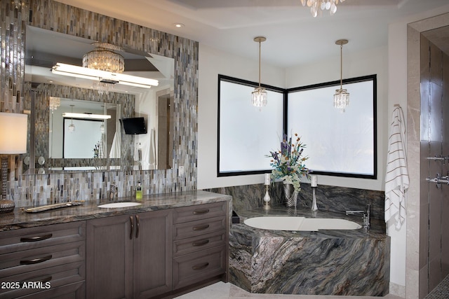 10205 E Happy Valley Rd, Scottsdale, AZ 85255 - full bathroom featuring a chandelier, vanity, decorative backsplash, and a bath