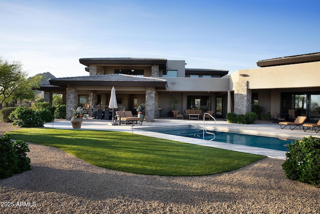 10205 E Happy Valley Rd, Scottsdale, AZ 85255 - back of property with a patio, stucco siding, an outdoor pool, and a lawn