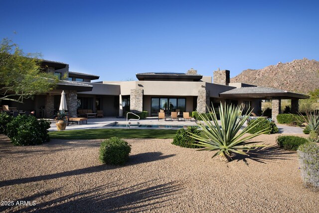 10205 E Happy Valley Rd, Scottsdale, AZ 85255 - back of property featuring stucco siding, a patio, an outdoor pool, and stone siding