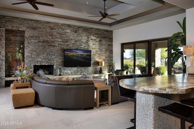 10205 E Happy Valley Rd, Scottsdale, AZ 85255 - living room with a ceiling fan, a fireplace, and a raised ceiling