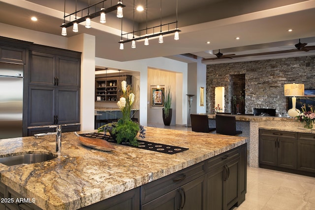 10205 E Happy Valley Rd, Scottsdale, AZ 85255 - kitchen featuring a ceiling fan, a sink, open floor plan, light stone counters, and recessed lighting