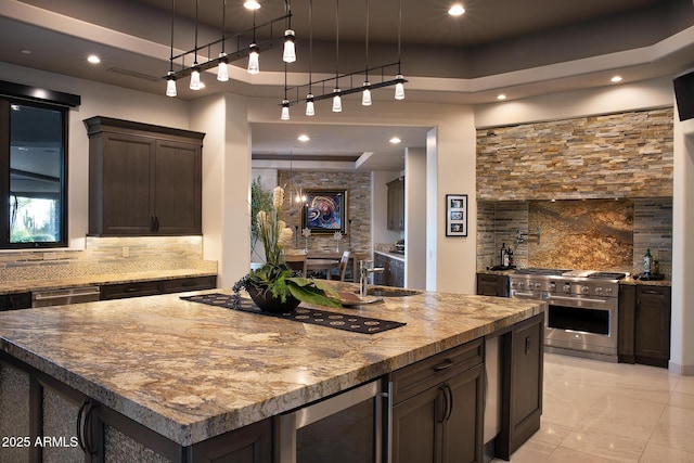 10205 E Happy Valley Rd, Scottsdale, AZ 85255 - bar area with appliances with stainless steel finishes, decorative backsplash, wine cooler, a sink, and a tray ceiling