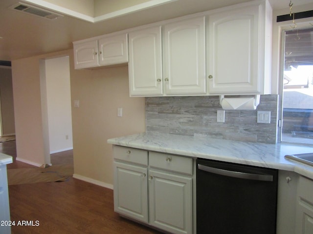 kitchen featuring stainless steel dishwasher, decorative backsplash, and white cabinets