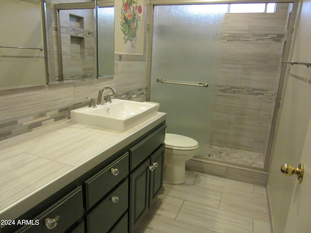 bathroom featuring vanity, tile patterned floors, decorative backsplash, toilet, and an enclosed shower