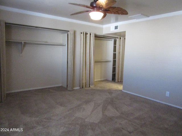 unfurnished bedroom featuring ceiling fan, a closet, carpet floors, and crown molding