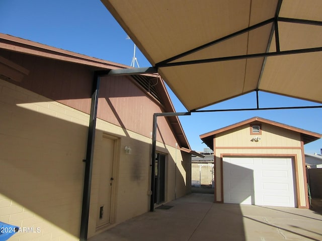 view of patio / terrace with an outbuilding and a garage