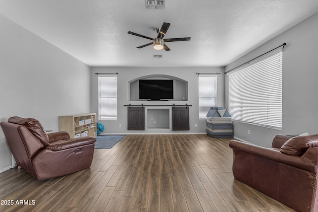 1405 S Honeysuckle Cir, Gilbert, AZ 85296 - living room featuring wood finished floors, a ceiling fan, baseboards, and a textured ceiling