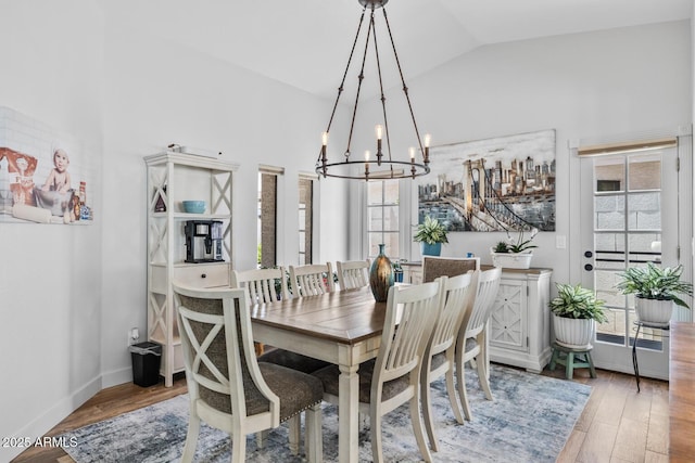 dining room with wood finished floors, a chandelier, and plenty of natural light