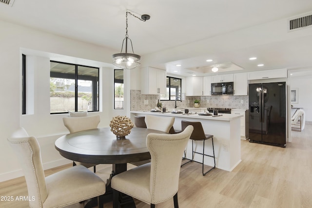 dining area with recessed lighting, light wood-style floors, visible vents, and baseboards