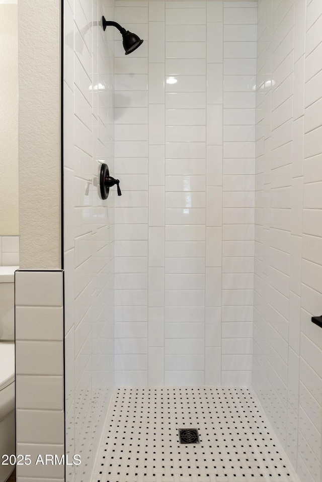 bathroom with tiled shower