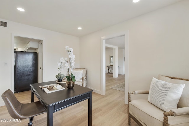 home office with visible vents, recessed lighting, light wood-type flooring, and baseboards