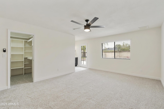 unfurnished bedroom featuring a spacious closet, multiple windows, carpet, and visible vents