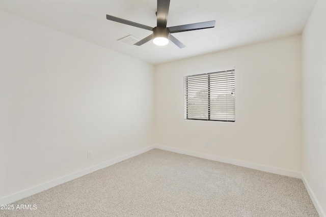 carpeted empty room with a ceiling fan and baseboards