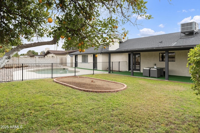 view of yard with a fenced in pool, cooling unit, and fence