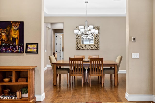 dining space with an inviting chandelier and wood-type flooring