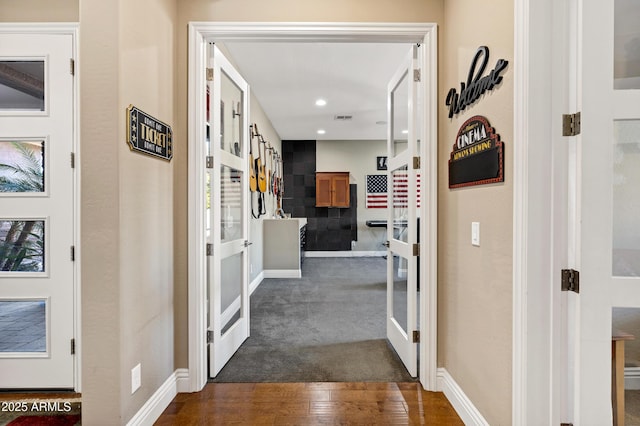 corridor featuring french doors and dark wood-type flooring