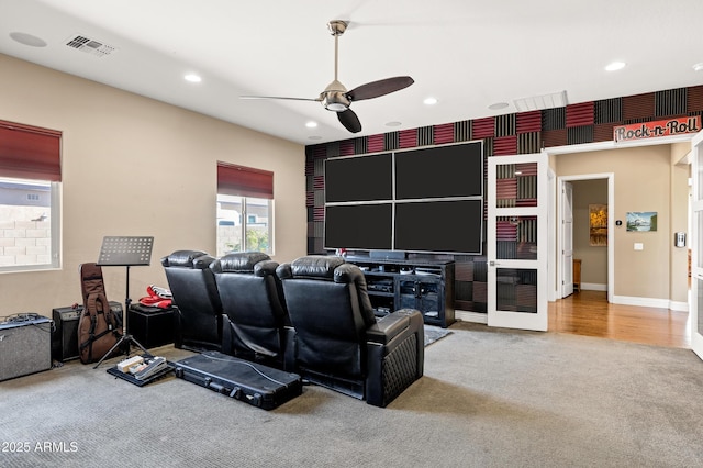 cinema room with carpet and ceiling fan