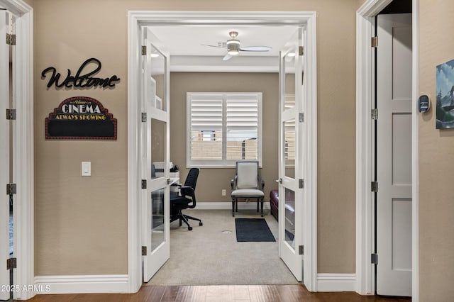 carpeted home office with french doors and ceiling fan