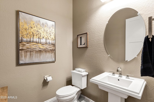 bathroom featuring sink and toilet