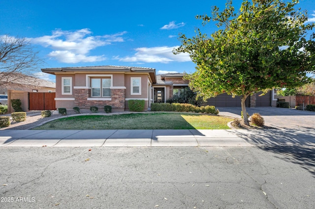 view of front of home featuring a garage and a front yard