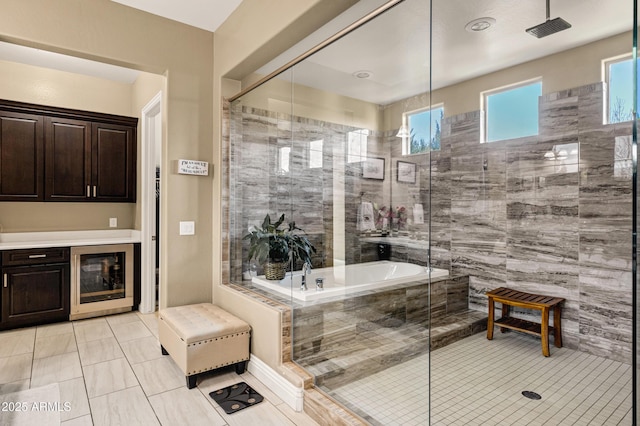 bathroom with independent shower and bath, plenty of natural light, tile patterned flooring, and wine cooler