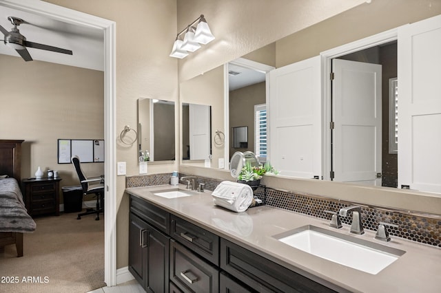 bathroom featuring ceiling fan, vanity, vaulted ceiling, and backsplash