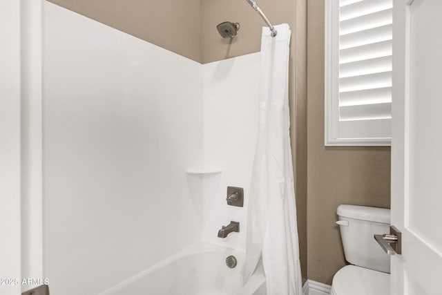 bathroom with shower / tub combo with curtain and toilet