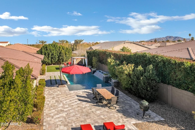 view of swimming pool with a mountain view and a patio area