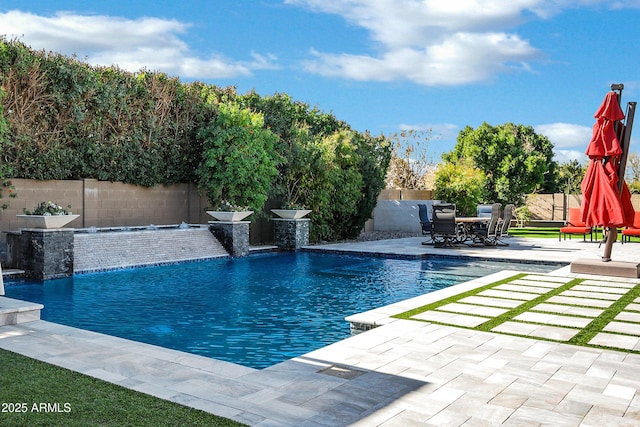 view of swimming pool with a patio and pool water feature