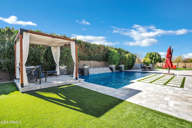 view of pool with pool water feature, a yard, and a patio area