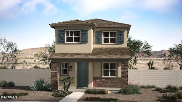 view of front of home with fence, a mountain view, and stucco siding