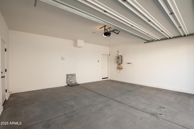 garage featuring water heater and baseboards