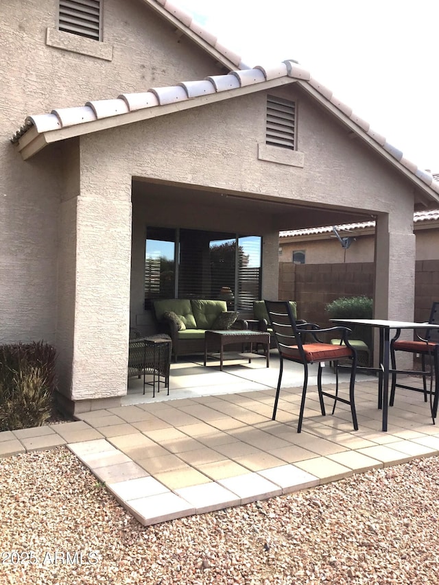 back of property with a patio and an outdoor living space