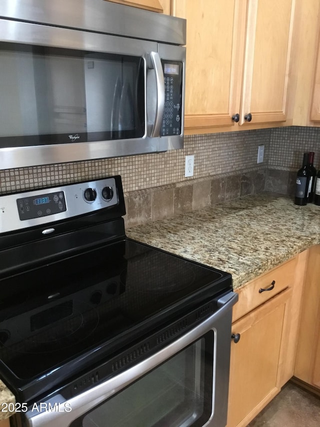 kitchen with light stone counters, appliances with stainless steel finishes, tasteful backsplash, and light brown cabinets