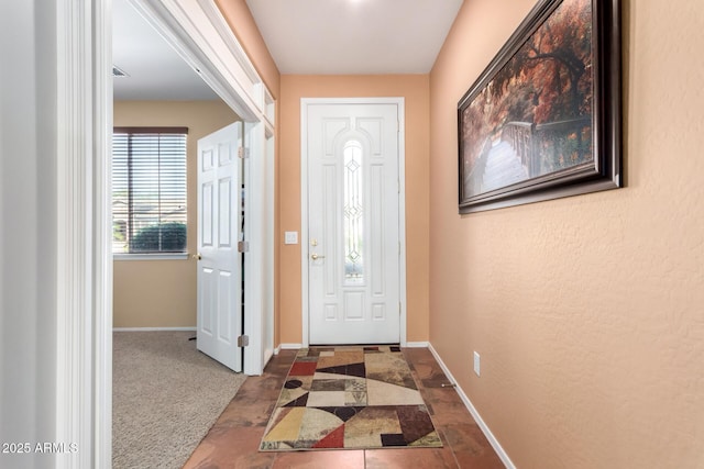 view of carpeted entrance foyer