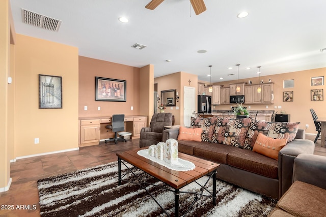 living room with built in desk and ceiling fan