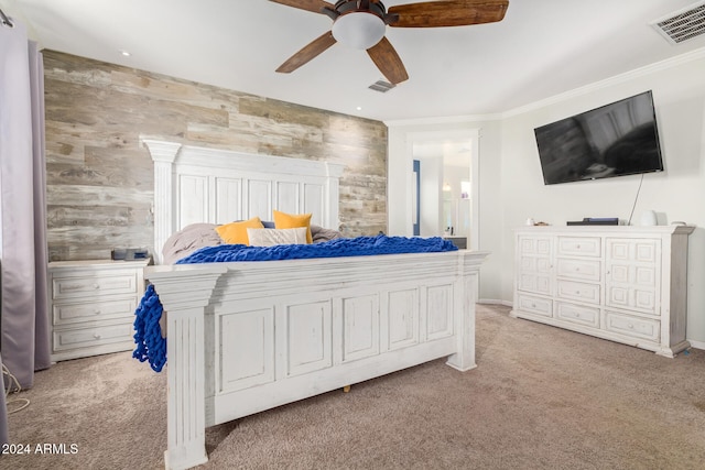 carpeted bedroom featuring ceiling fan and ornamental molding