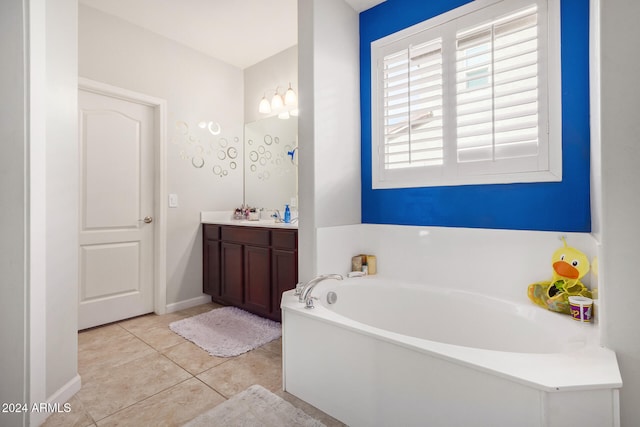 bathroom with vanity, tile patterned floors, and a bathtub