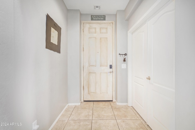 doorway to outside featuring light tile patterned floors