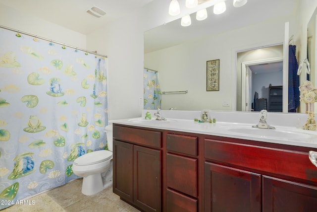 bathroom with tile patterned floors, curtained shower, vanity, and toilet