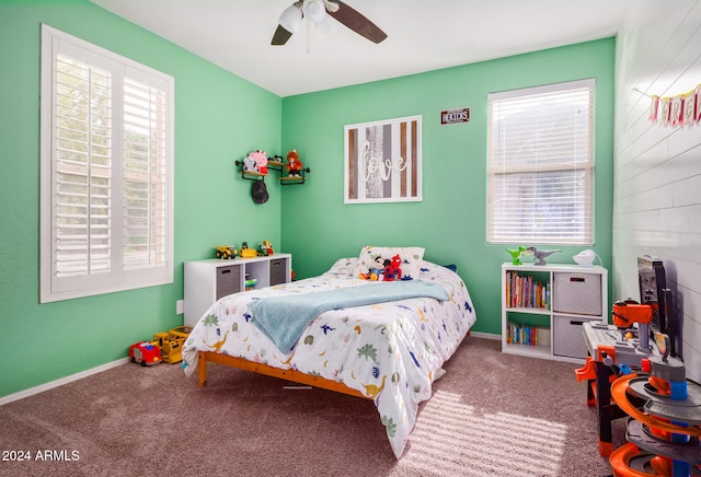 carpeted bedroom with multiple windows and ceiling fan