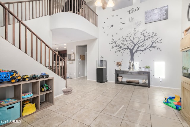 entryway featuring tile patterned floors and a towering ceiling