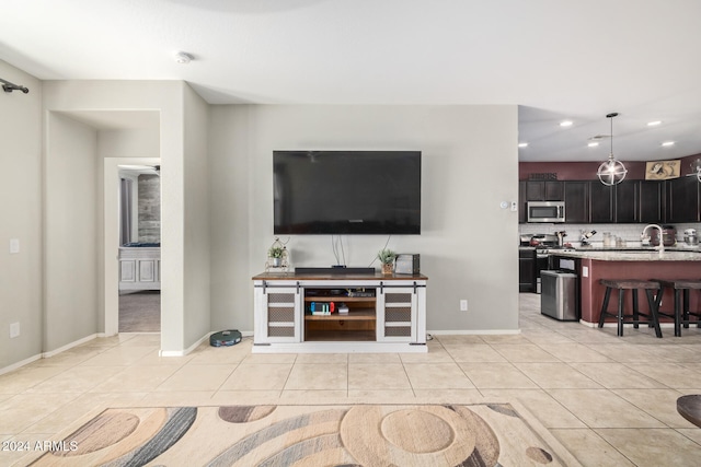 living room featuring sink and light tile patterned flooring