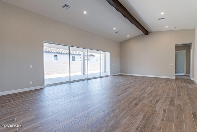 unfurnished room with vaulted ceiling with beams, baseboards, visible vents, and wood finished floors