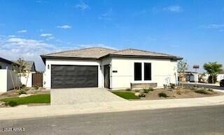 view of front of home with concrete driveway and an attached garage