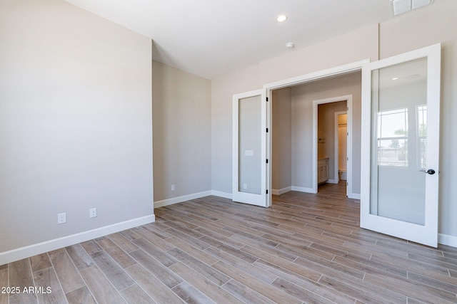 unfurnished bedroom with light wood-style floors, recessed lighting, visible vents, and baseboards