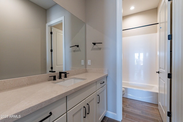 full bath with recessed lighting, toilet, wood tiled floor, vanity, and shower / bathing tub combination